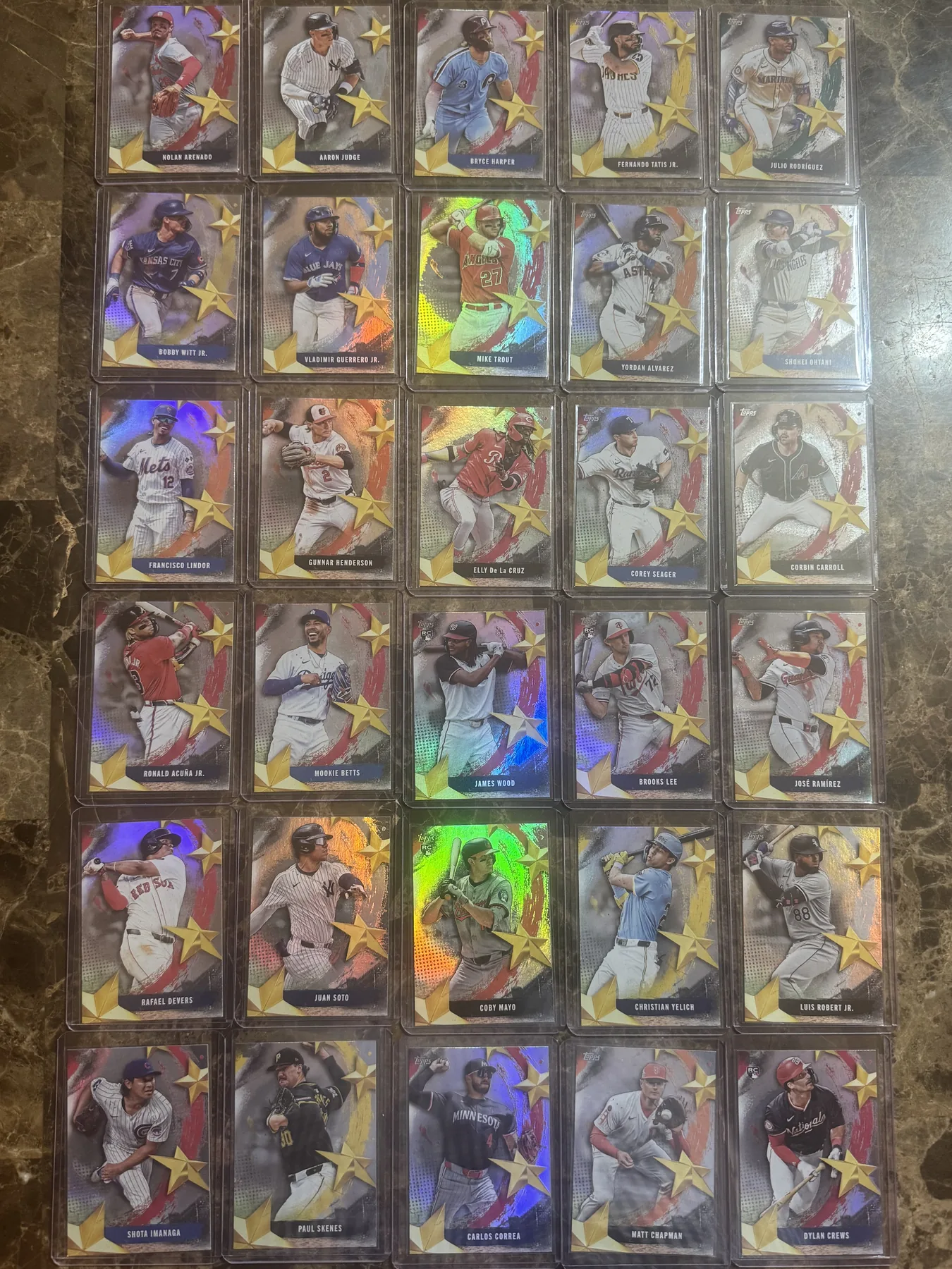 Collection of holographic star insert baseball cards laid out in grid