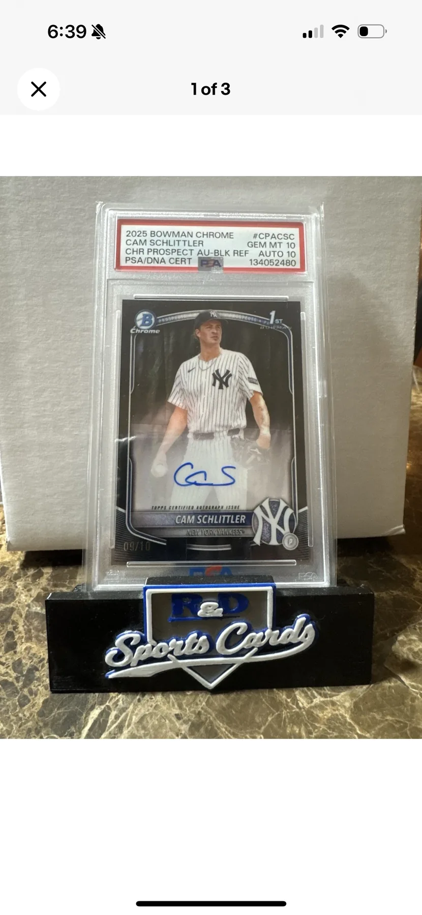 PSA graded card displayed on R&D Sports Cards branded stand